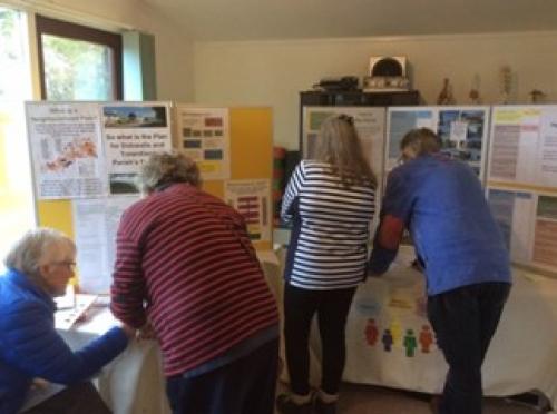 Residents studying posters at one of our exhibition days